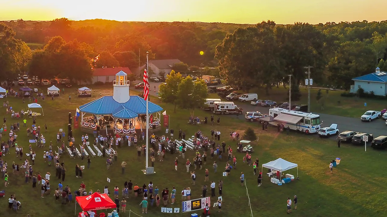 An aerial view of a fairground crowd at sunset