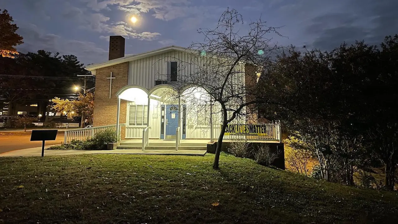 A small historic library glows at dusk