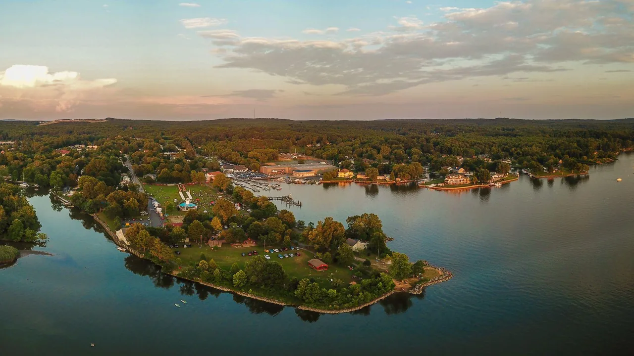 An aerial view of a wooded island at sunset