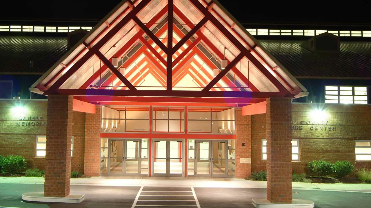 A lit timber entrance to a brick building