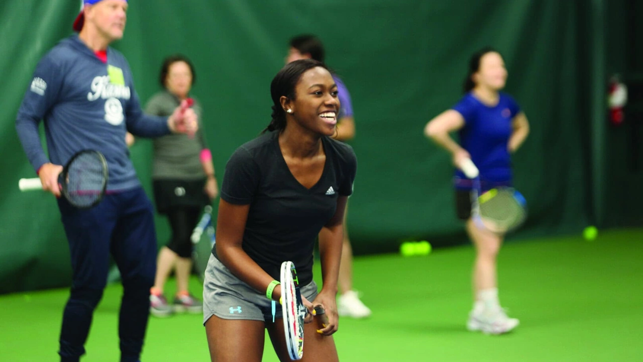 Players rally on an indoor tennis court