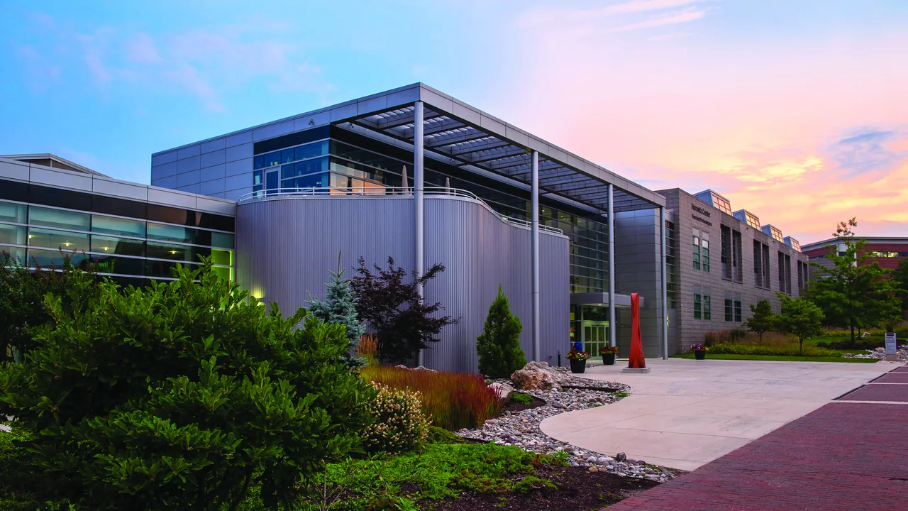 A modern arts building at sunset