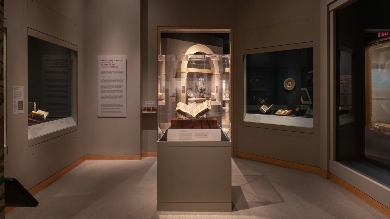 A dim museum gallery with illuminated display cases holding manuscripts and objects.