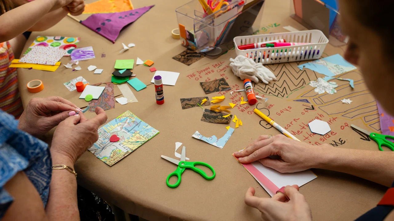 Hands busy at a crowded craft table