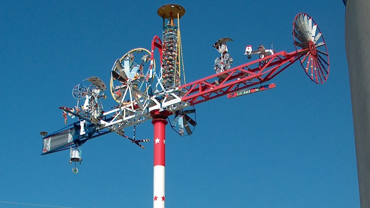 A colorful whirligig against a blue sky
