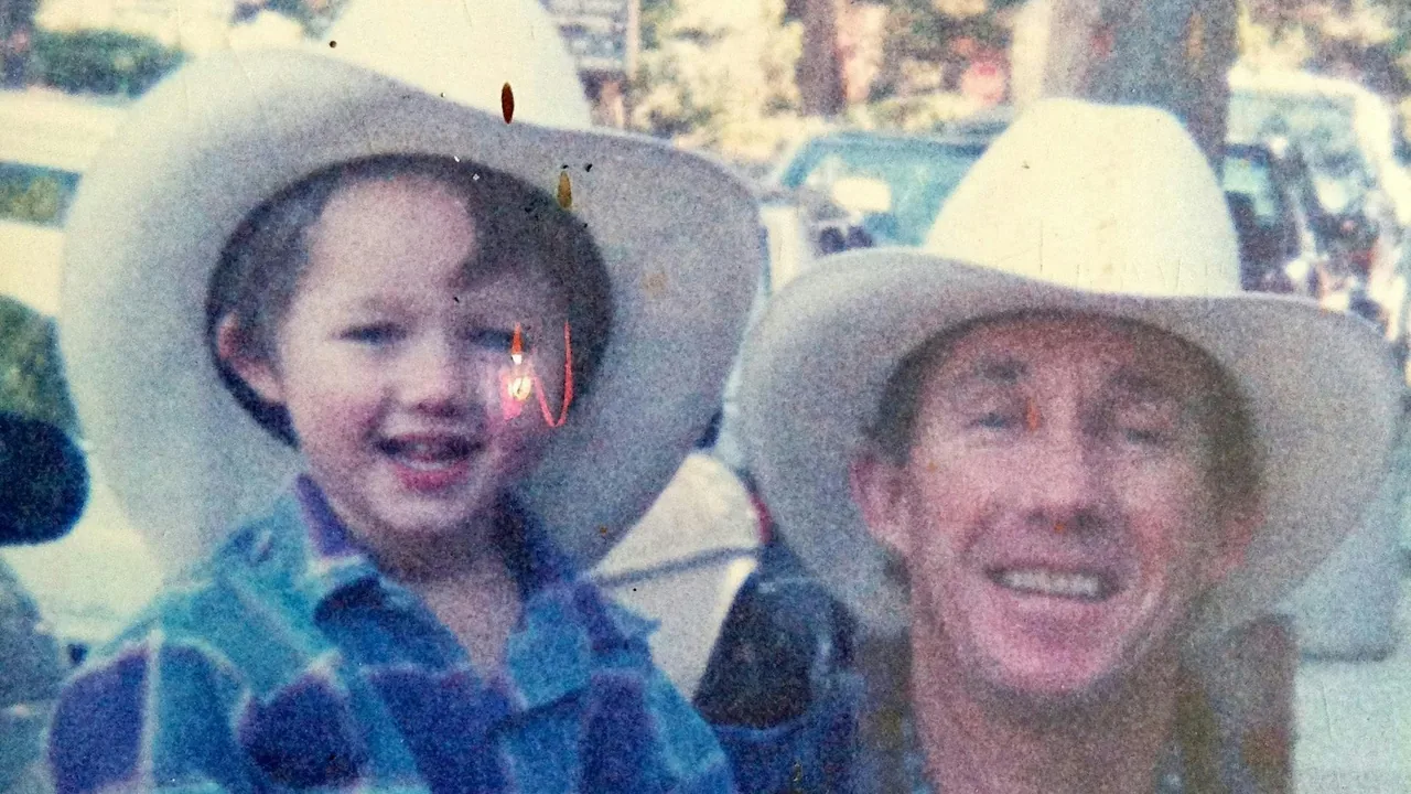 A vintage photo of a boy and man in cowboy hats
