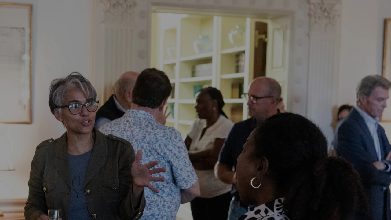 A tour group gathers in a historic house