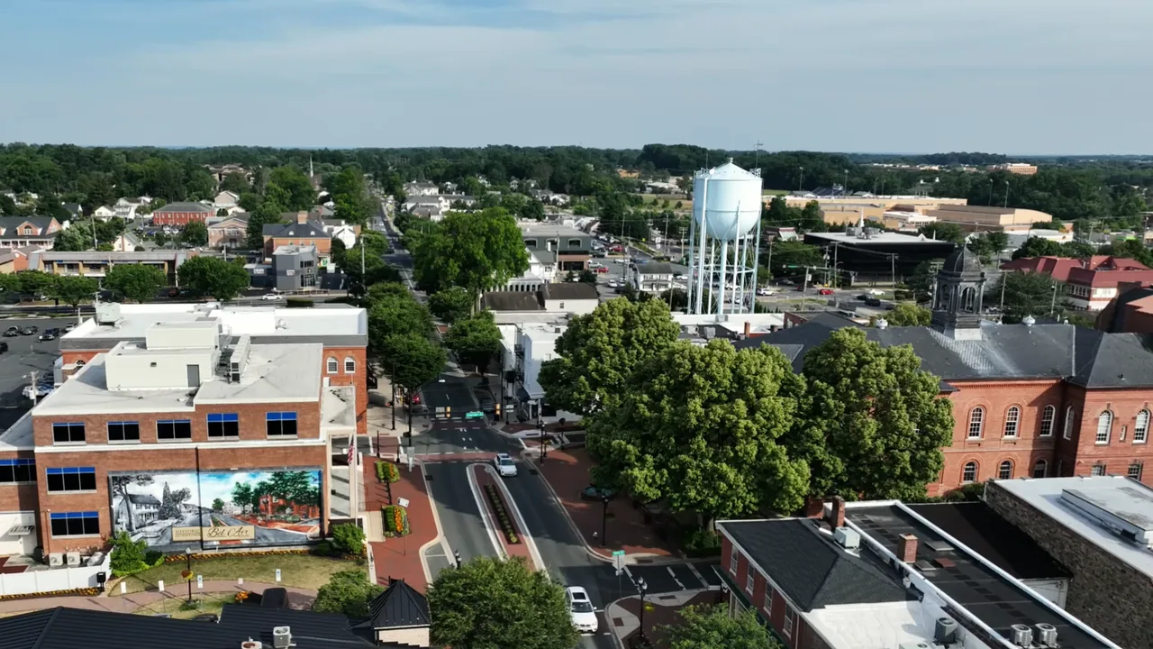 An aerial view of a small city with a water tower