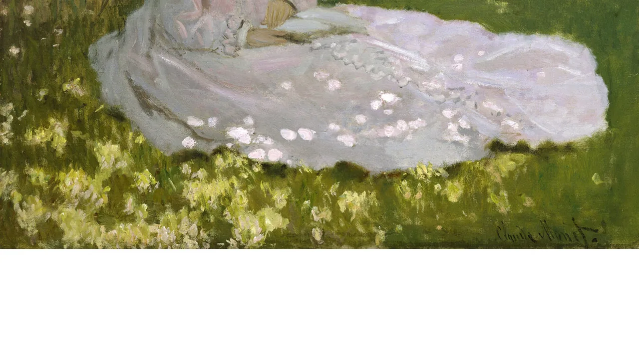 A white lace gown laid on green grass