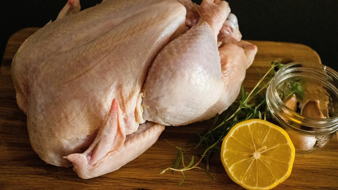 A raw turkey with lemon and herbs
