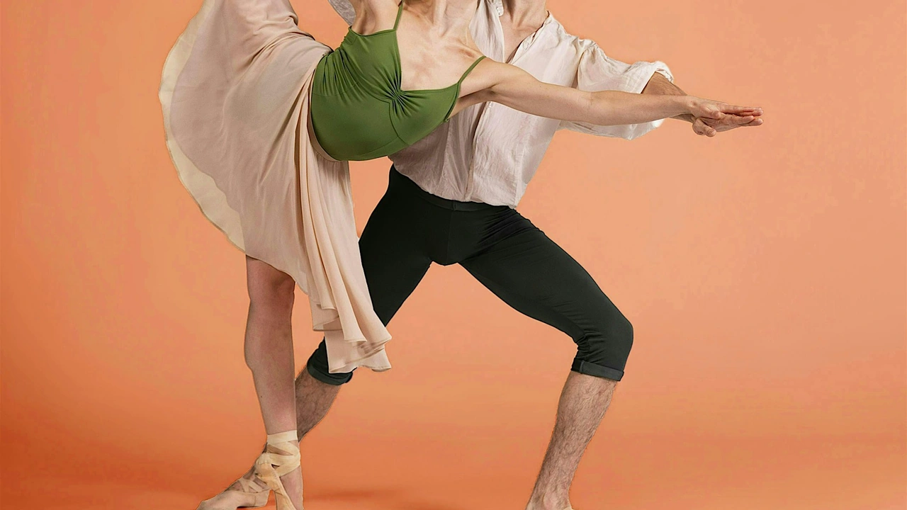Two dancers move against a peach backdrop