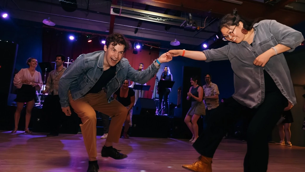 Dancers swing on a ballroom floor