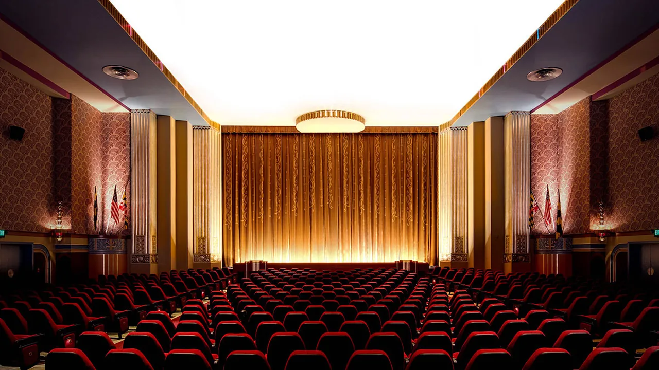 An empty auditorium with red seats