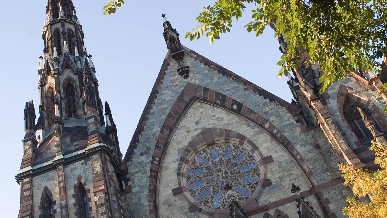 A Gothic stone church against a blue sky