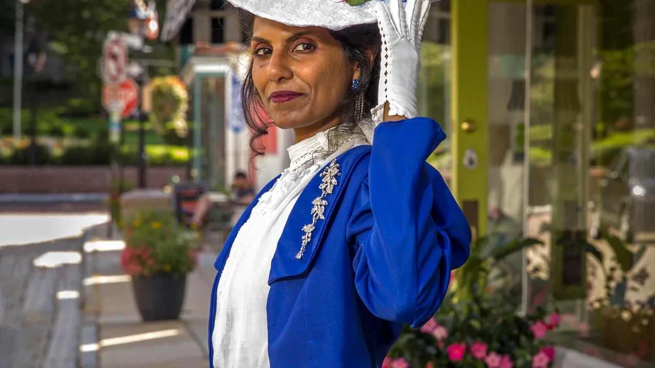 A woman in a royal blue costume outdoors