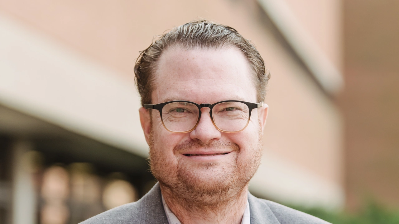 A smiling man in glasses
