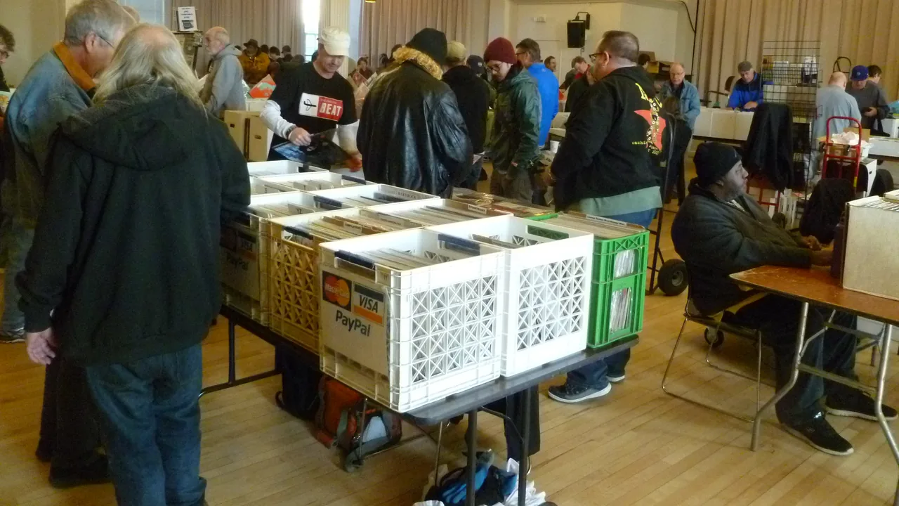 Shoppers browse crates of CDs and records at the Carrboro record show