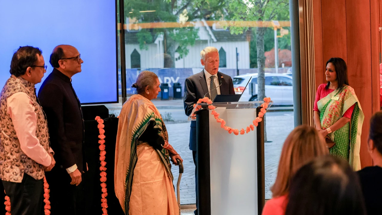 Speakers gather at a podium for a Diwali celebration