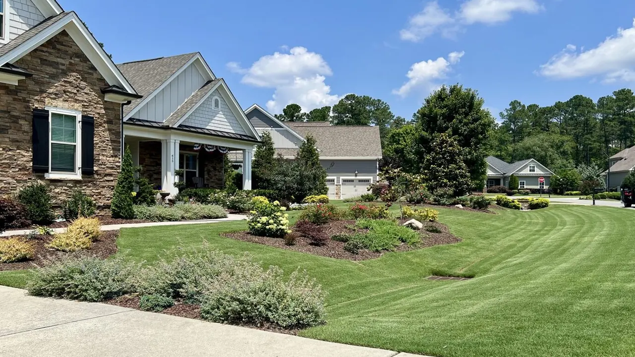 A stone house with a manicured lawn