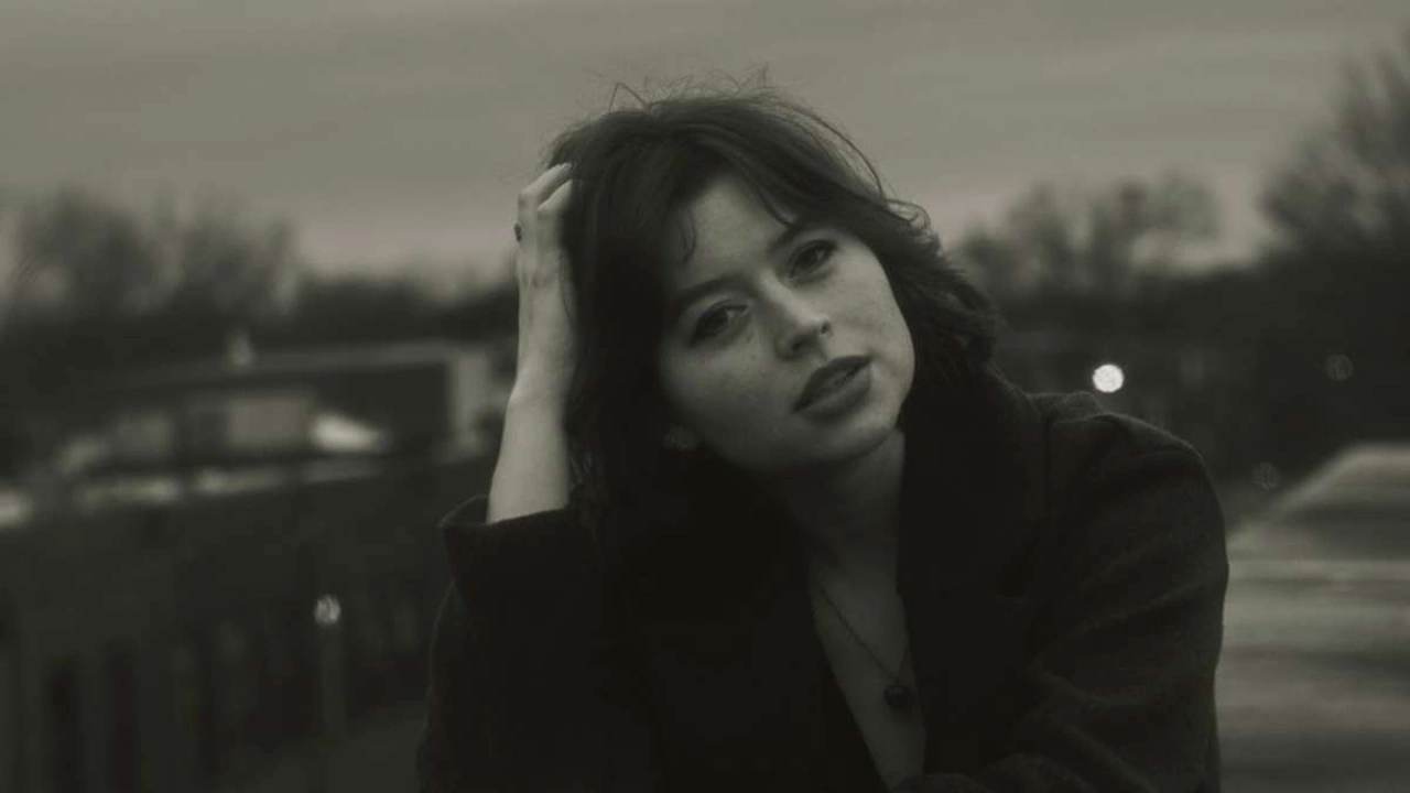 A woman with dark hair in black and white