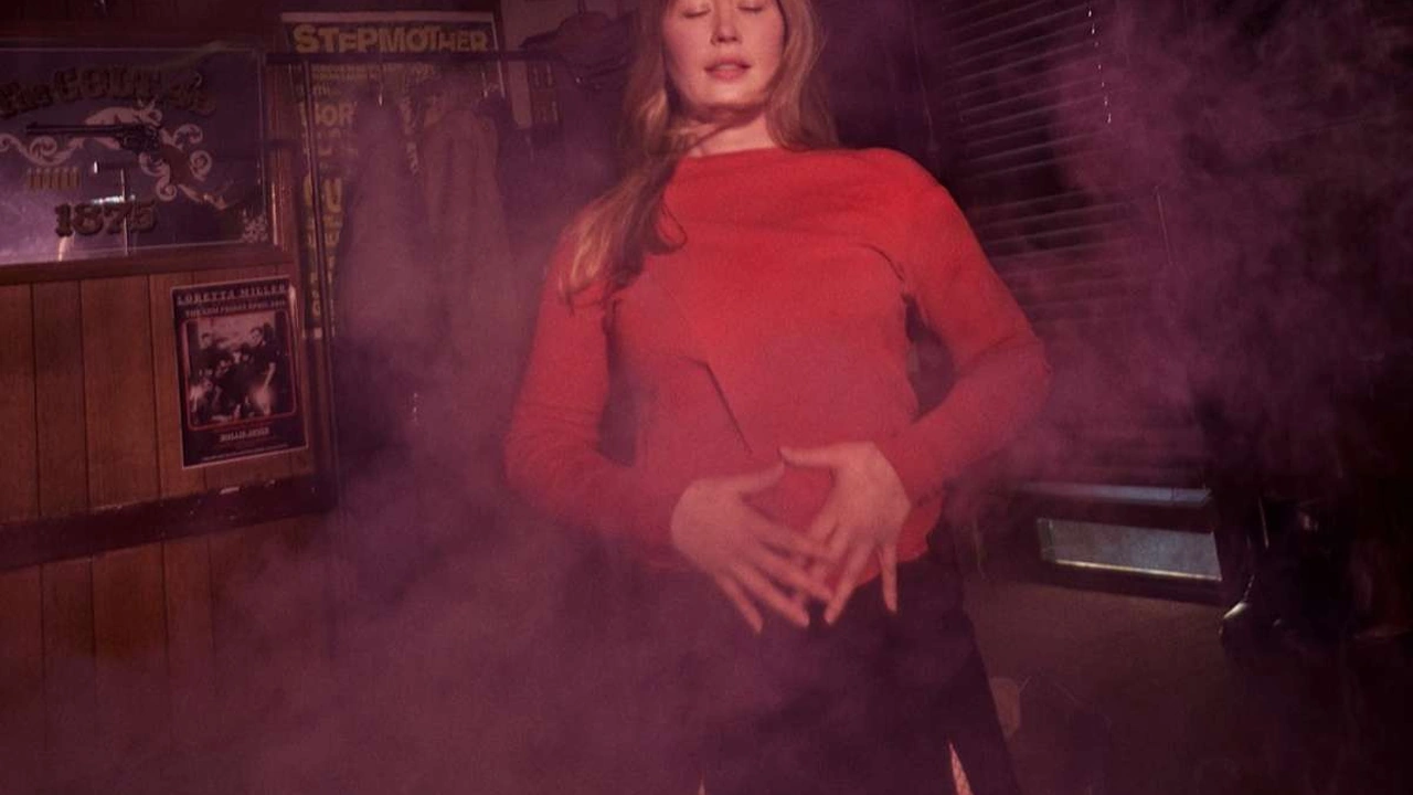 A woman in red in a smoky room