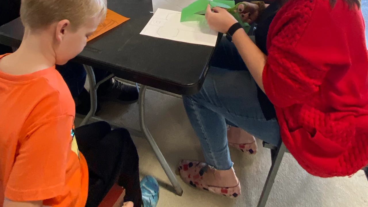 Kids work on crafts at a table