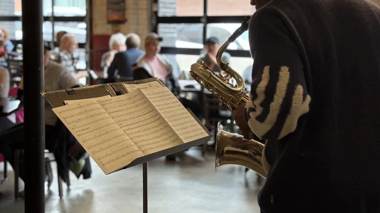A saxophonist plays in a busy restaurant