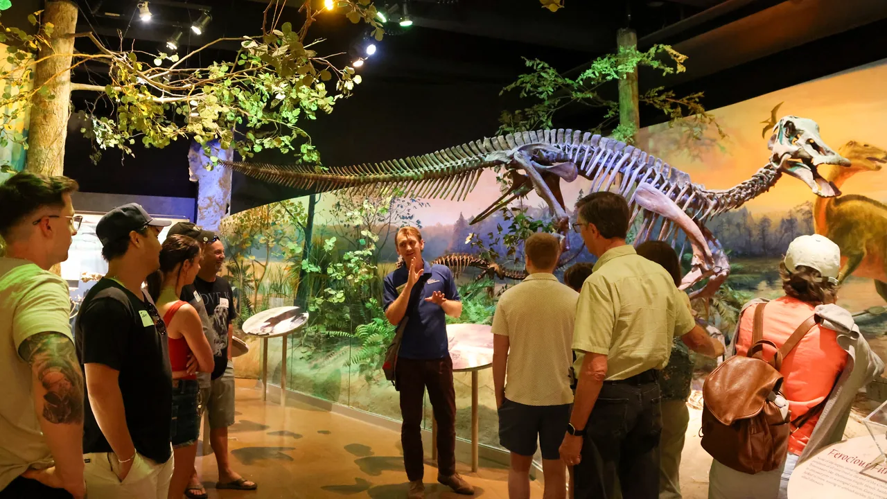 Visitors explore a dinosaur exhibit