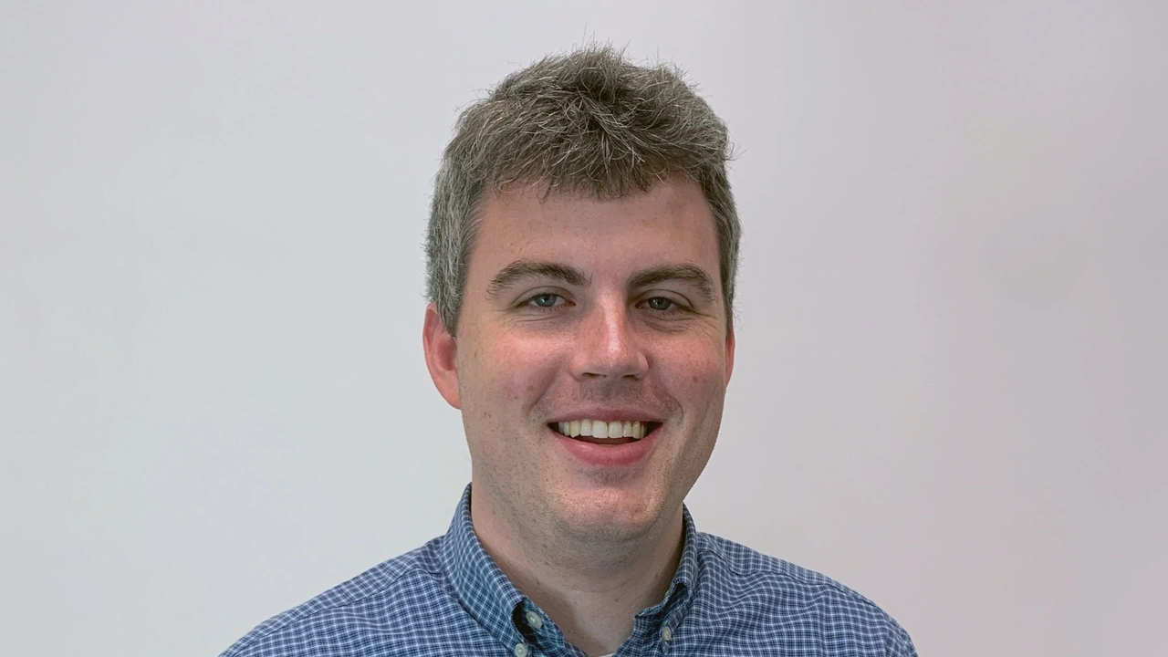 A smiling man in a blue shirt