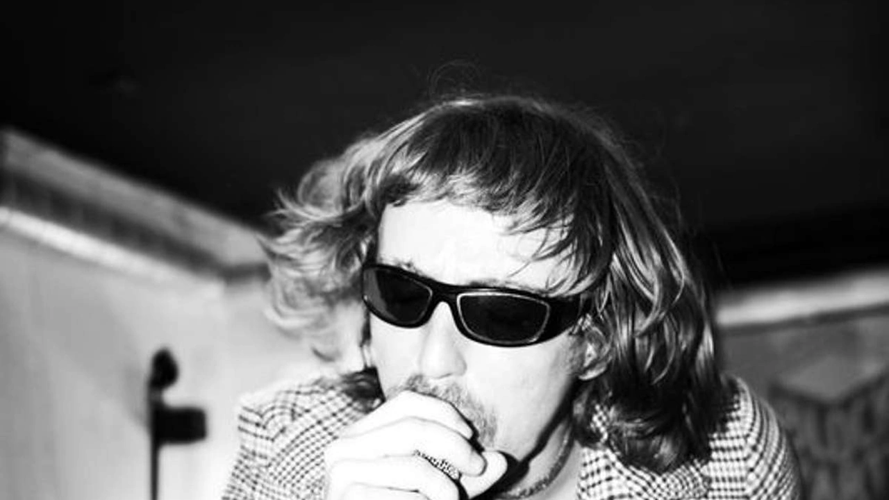 A musician in sunglasses in black and white