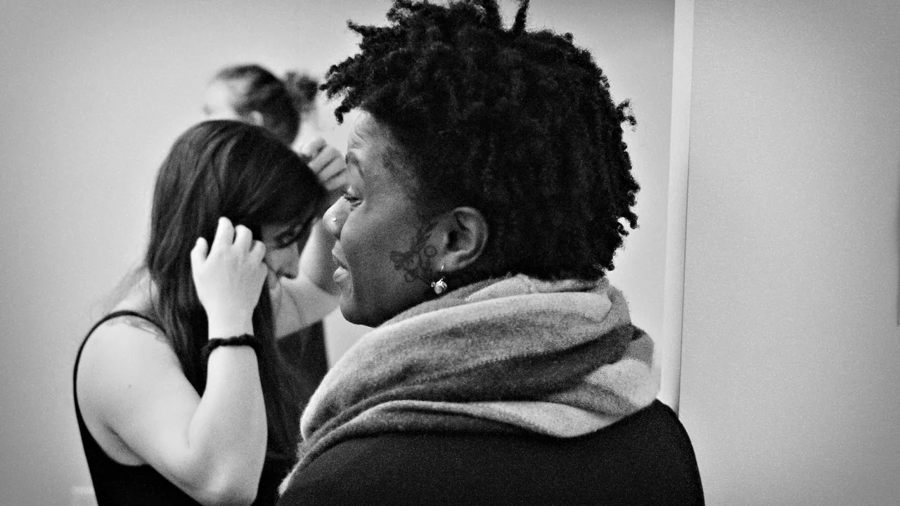 Two audience members laugh at a Black Sheep Comedy show