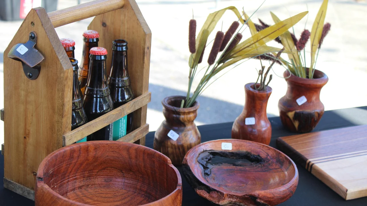 Handmade wooden bowls and pottery on a market table