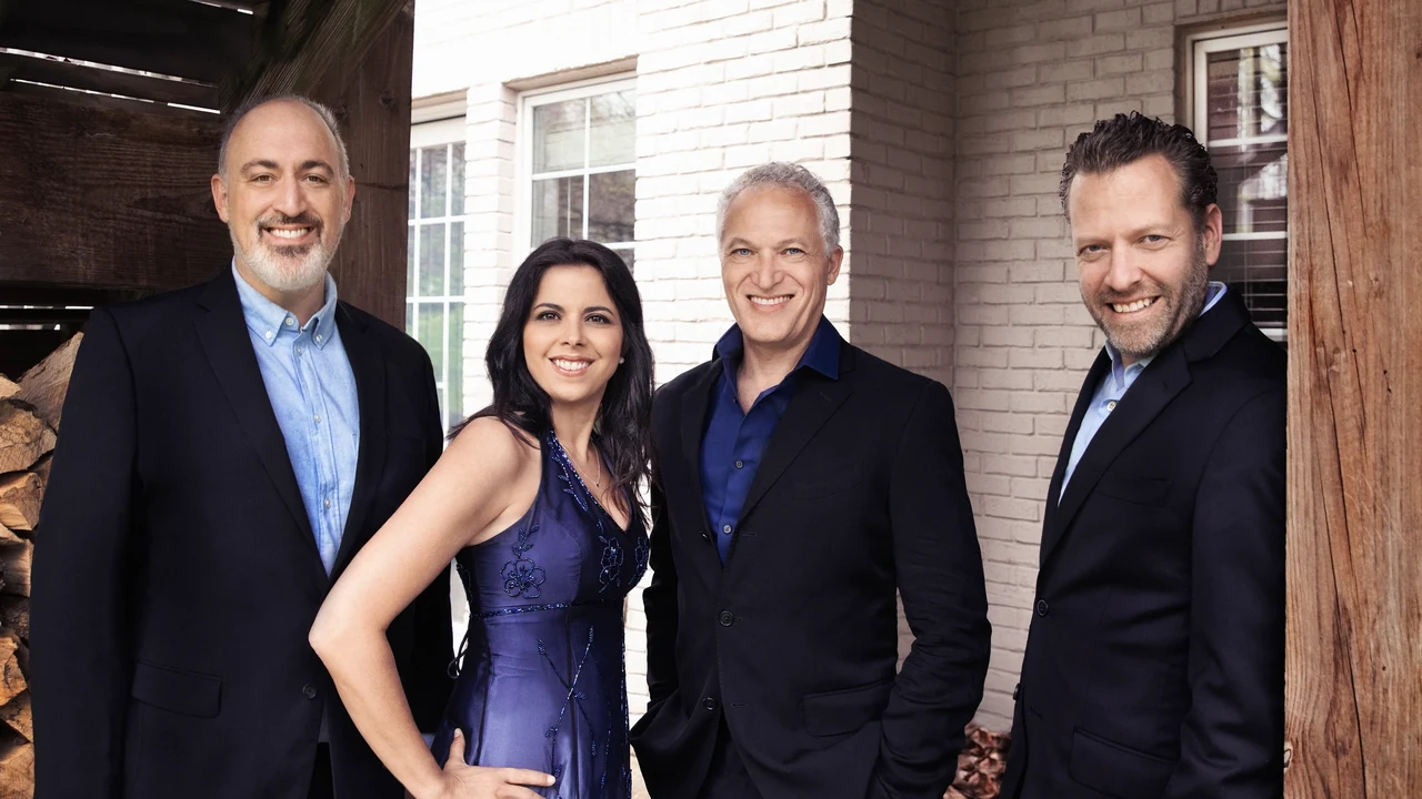 A vocal quartet poses in formal wear