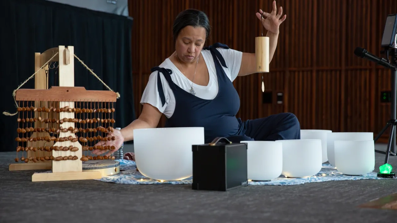 A performer plays crystal singing bowls