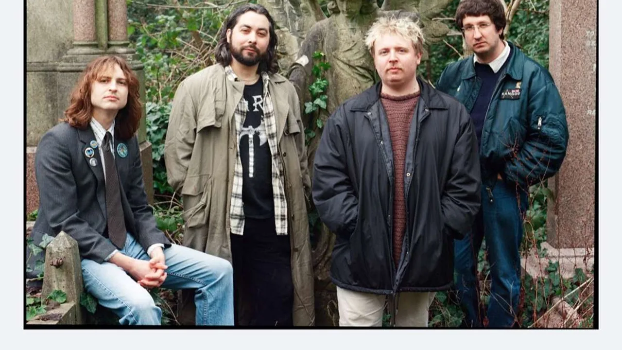Four band members pose in a garden