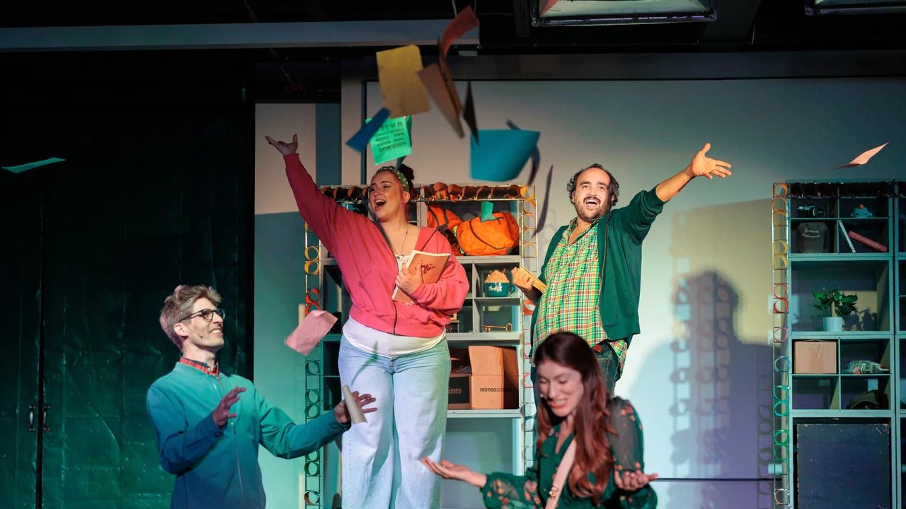 Actors perform an energetic scene on a colorful stage set
