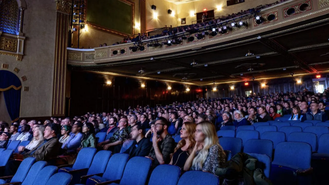 A packed audience in a historic movie palace