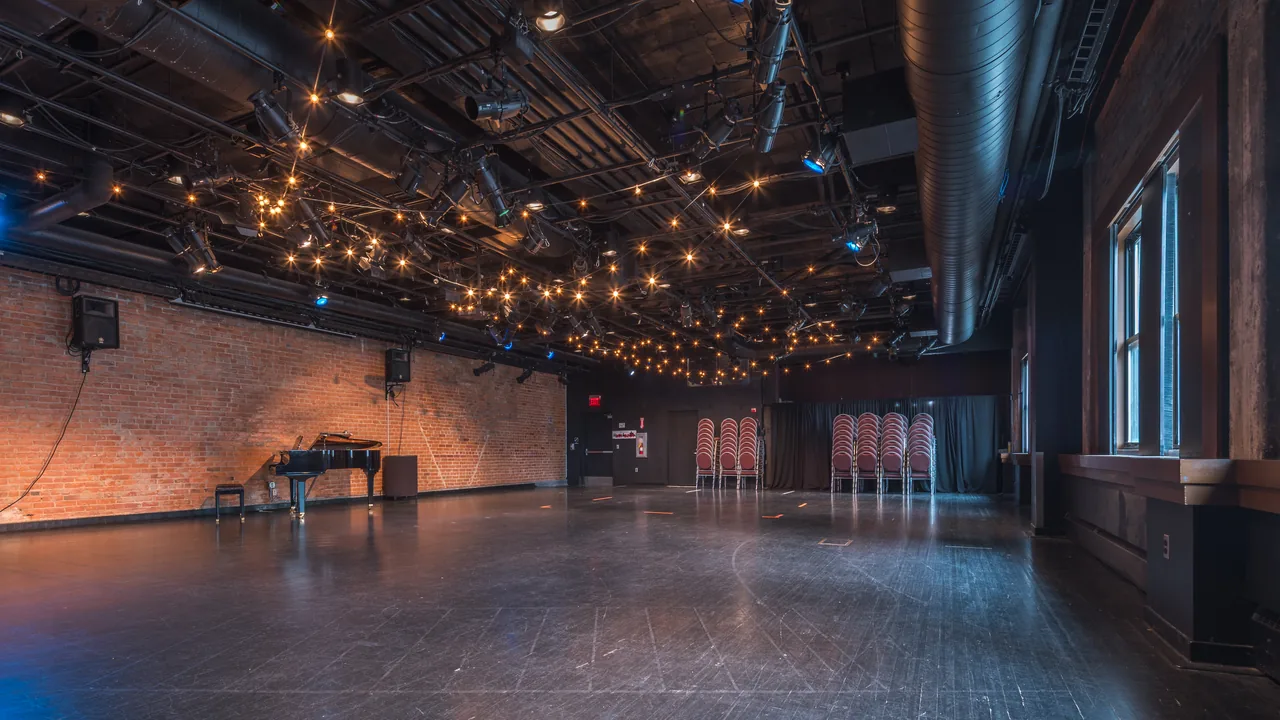 An event hall with brick walls and strings of lights