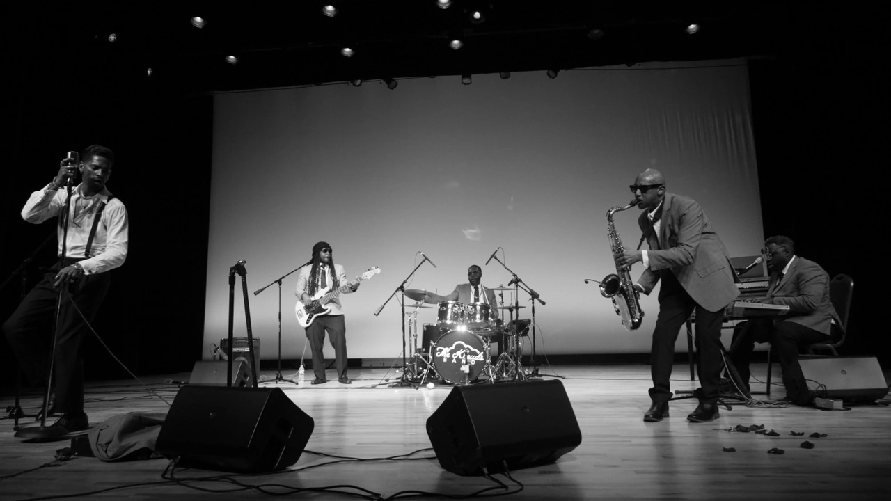 A band performs on a stage in a black-and-white photo