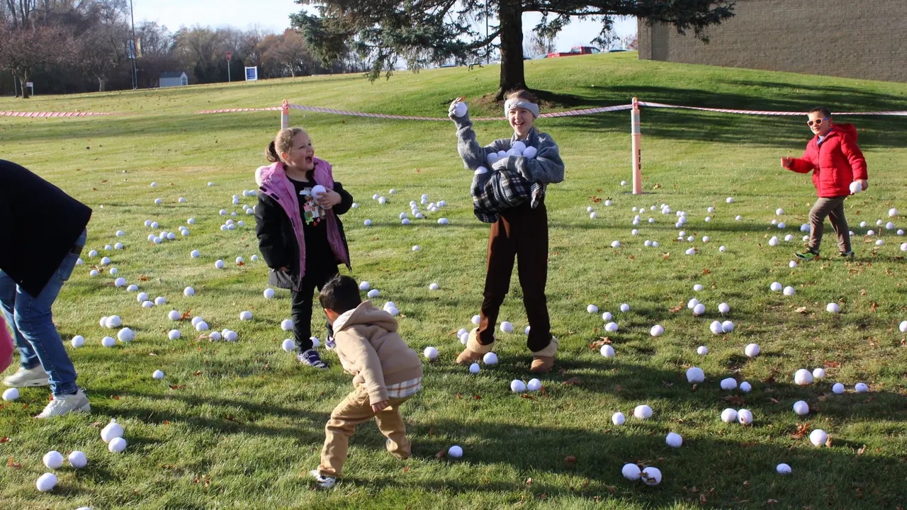 Children hunt for eggs on a sunny lawn