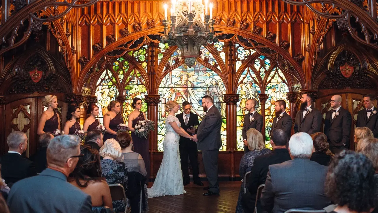 A wedding ceremony in an ornate carved-wood chapel