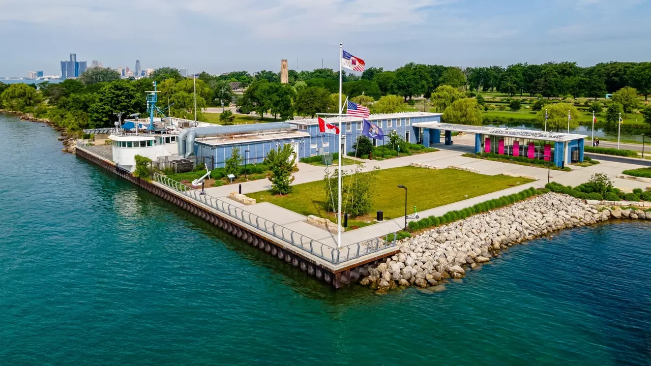 An aerial view of a waterfront park and buildings on a river
