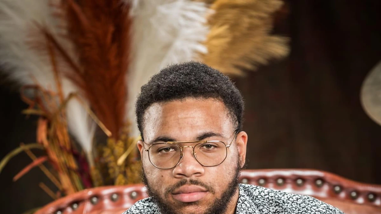 Portrait of a young man in glasses before dried pampas grass
