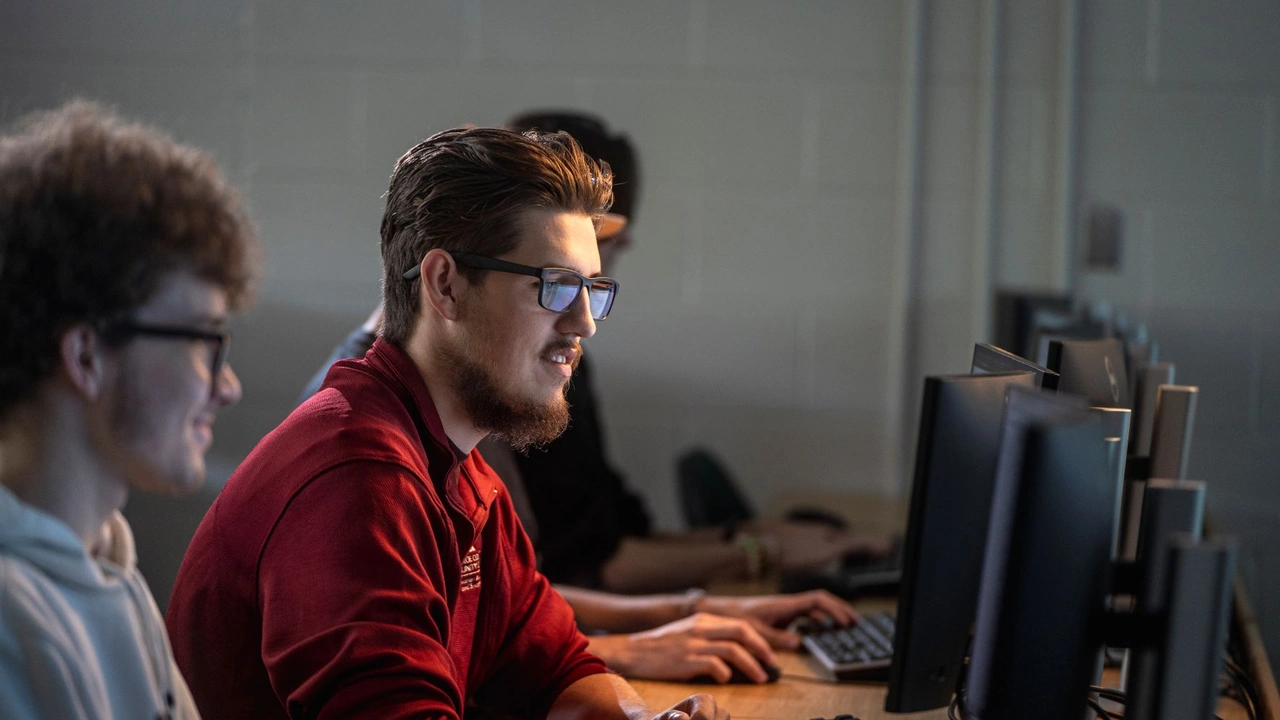 Young men play at computers in a lab