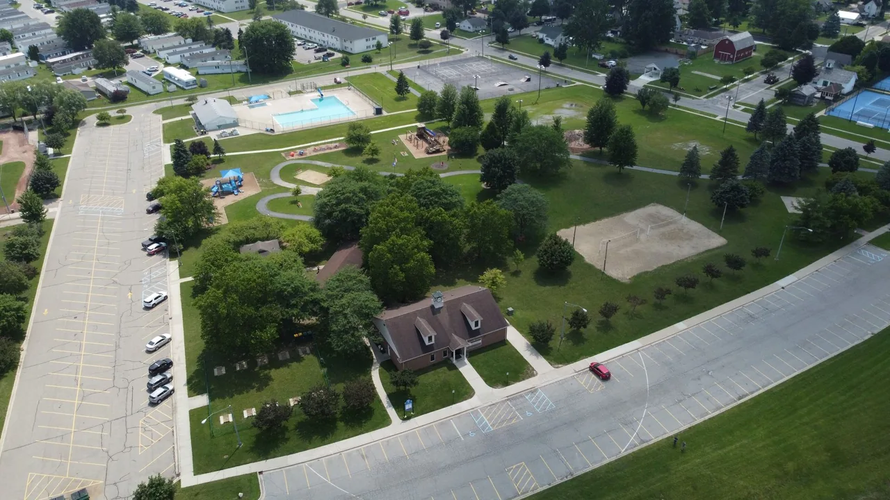 An aerial view of a park and neighborhood streets