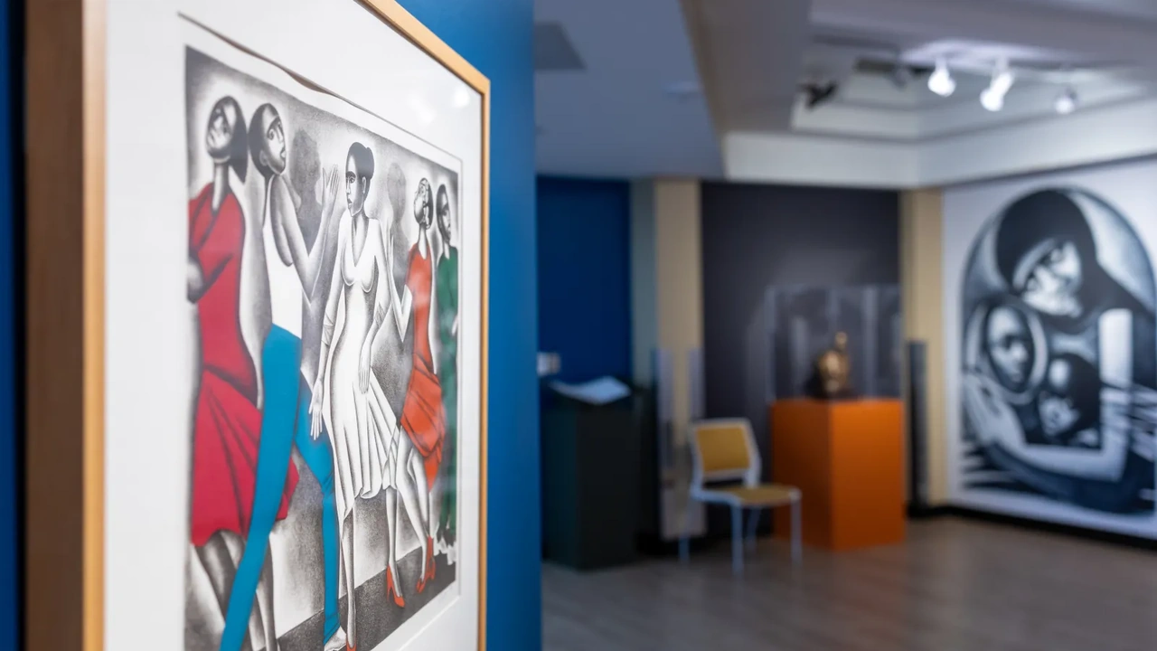 Paintings hang in a bright gallery with display cases