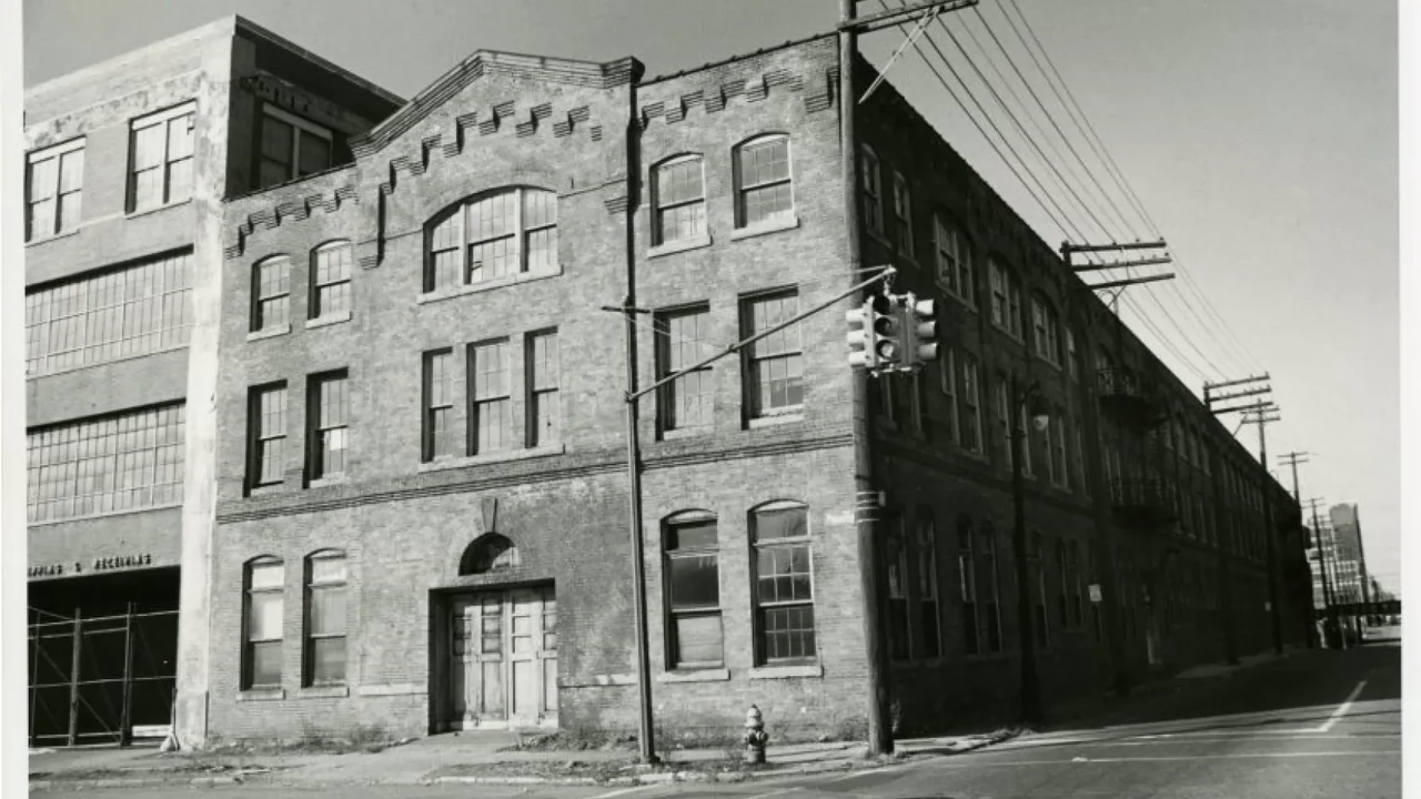 A historic brick factory building in black and white