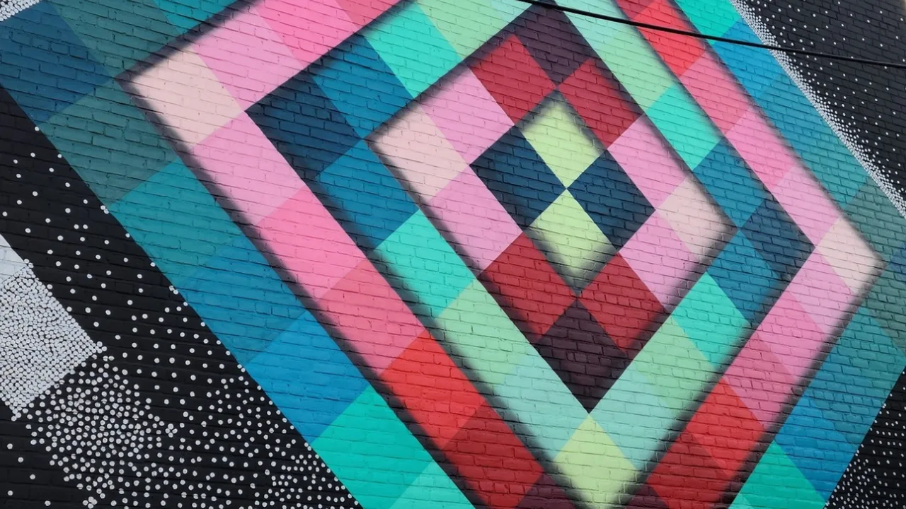 A colorful handmade quilt with a diamond pattern